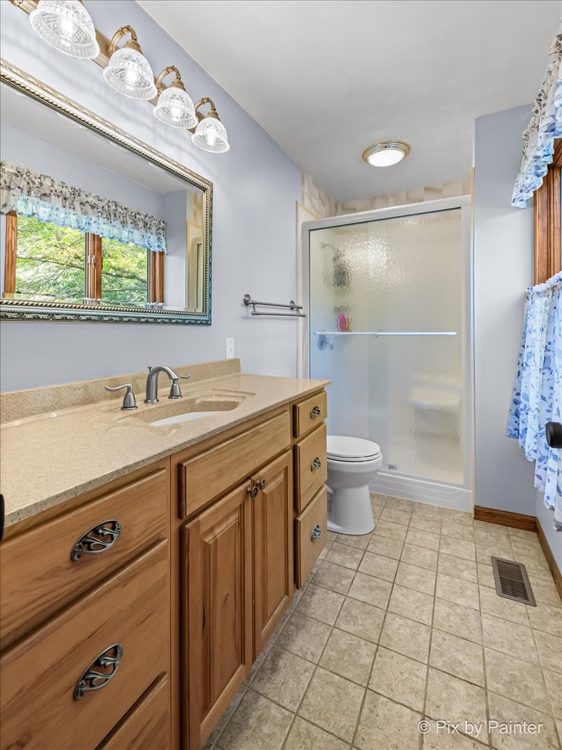 6403 Ridgeview Drive Huntley, IL 60142 - Photo 15 of 35 a spacious bathroom with a granite countertop sink a toilet a mirror and shower