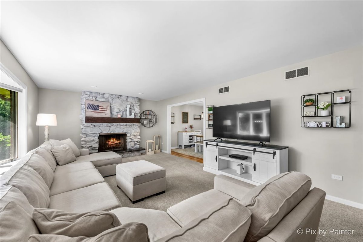 6403 Ridgeview Drive Huntley, IL 60142 - Photo 4 of 35 a living room with furniture a flat screen tv and a fireplace