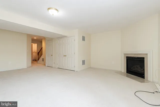 a view of an empty room with a fireplace