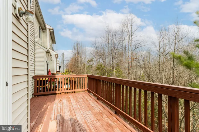 a view of balcony with wooden floor and fence