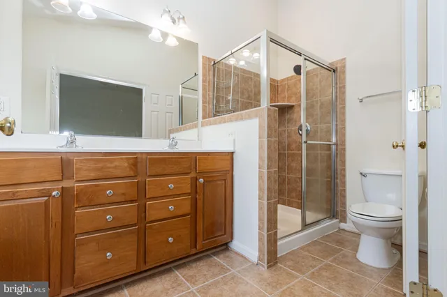 a bathroom with a toilet a sink and glass door