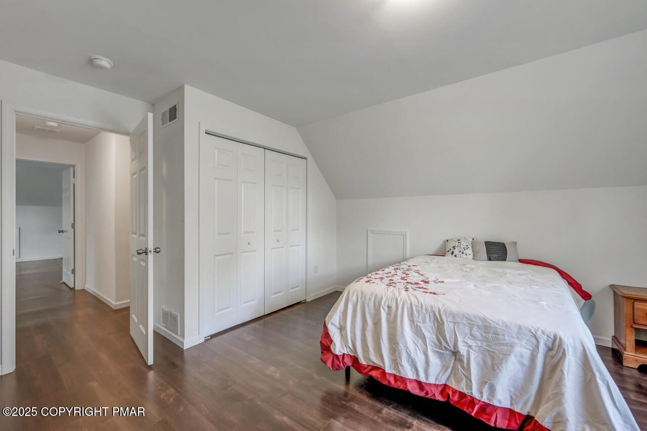 207 Game Lane Blakeslee, PA 18610 - Photo 44 of 55 a bedroom with a bed and wooden floor
