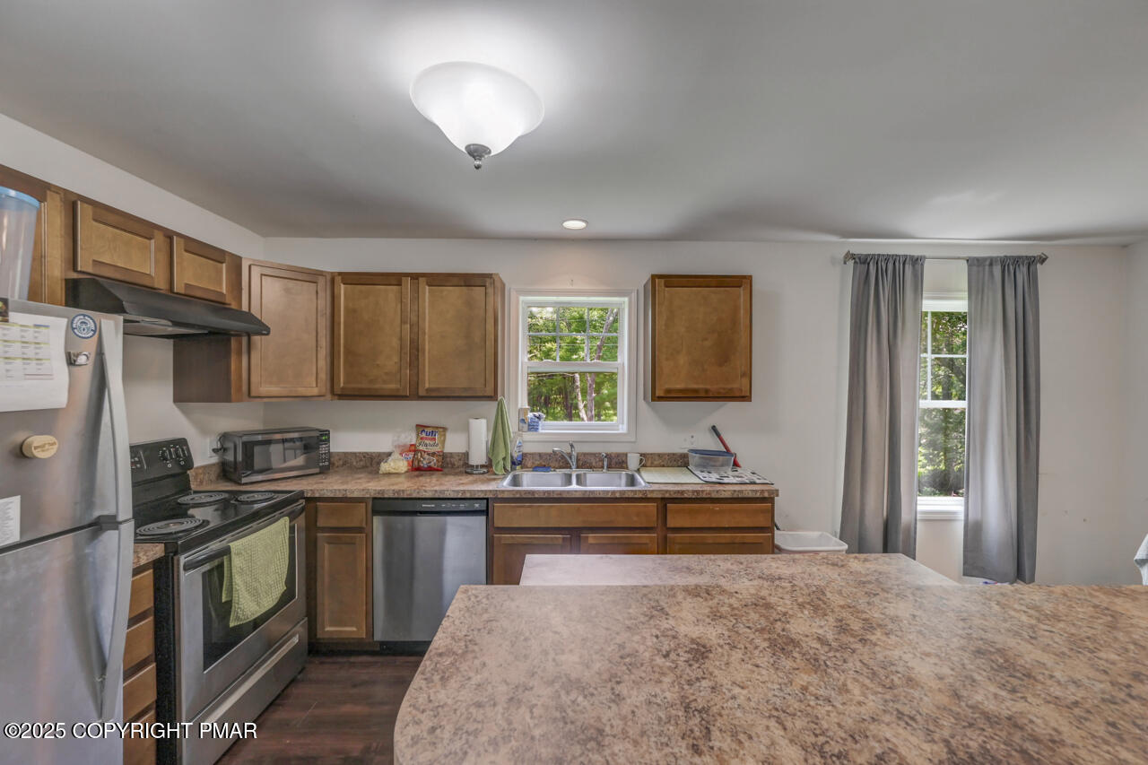 207 Game Lane Blakeslee, PA 18610 - Photo 8 of 55 a kitchen with a sink stove and refrigerator