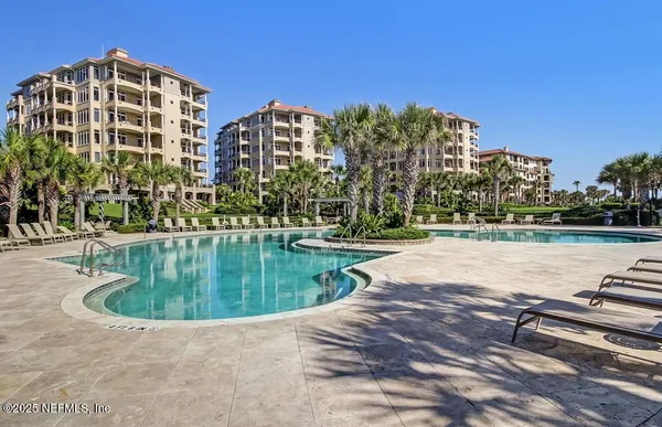 a swimming pool with outdoor space and seating area