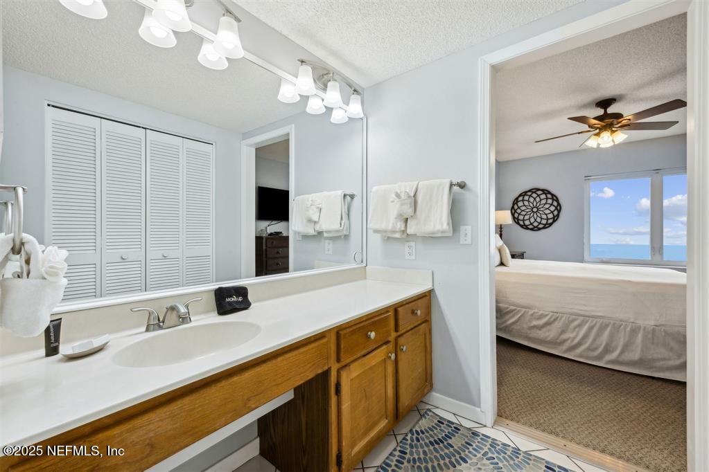 1854 Turtle Dunes Place Fernandina Beach, FL 32034 - Photo 24 of 56 a spacious bathroom with a granite countertop double vanity sink a mirror and a shower