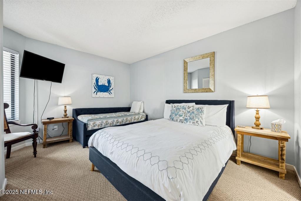 1854 Turtle Dunes Place Fernandina Beach, FL 32034 - Photo 27 of 56 a bedroom with double bed and a flat screen tv