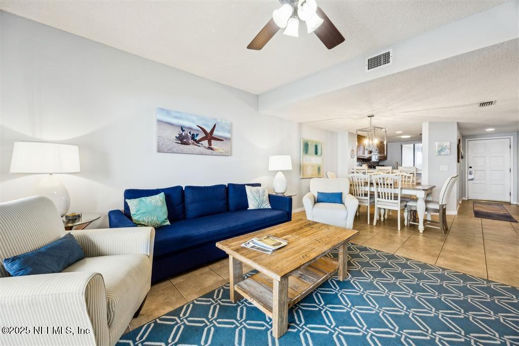 1854 Turtle Dunes Place Fernandina Beach, FL 32034 - Photo 10 of 56 a living room with furniture a rug and a chandelier