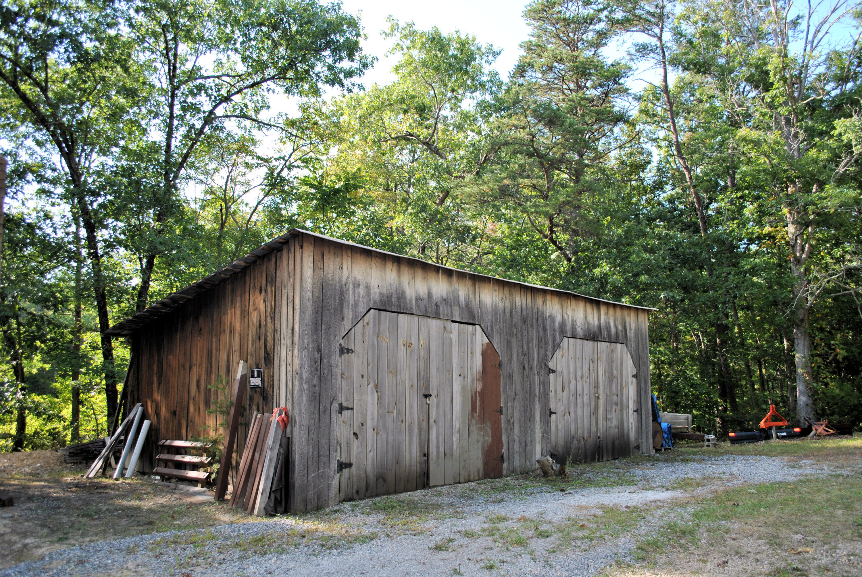 3948 Flatwoods Road Elliston, VA 24087 - Photo 25 of 57 a backyard of a house with lawn chairs and a large tree