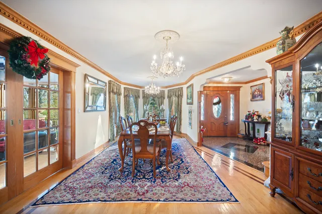 a living room with dining room and wooden floor
