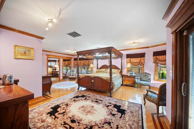 a bedroom with a bed and glass windows