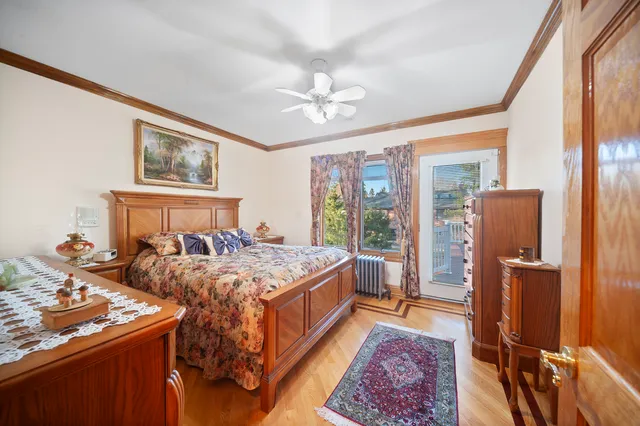 a bedroom with bed and wooden floor