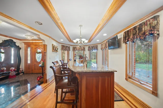 a dining room with furniture wooden floor and a chandelier