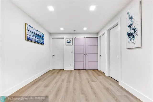 a view of hallway with wooden floor