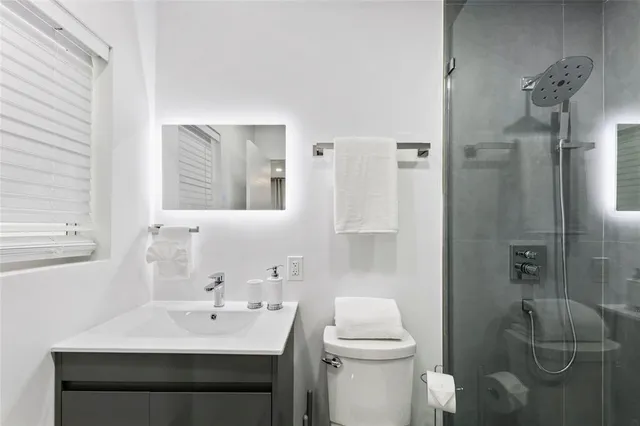 a bathroom with a sink toilet and shower