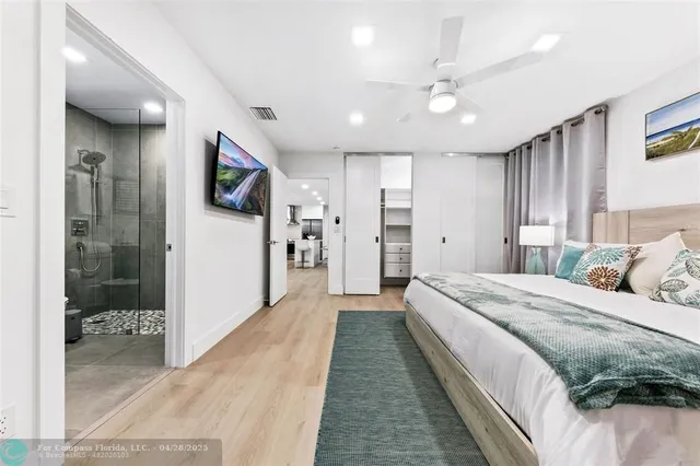 a large bedroom with a large bed and a walk in closet