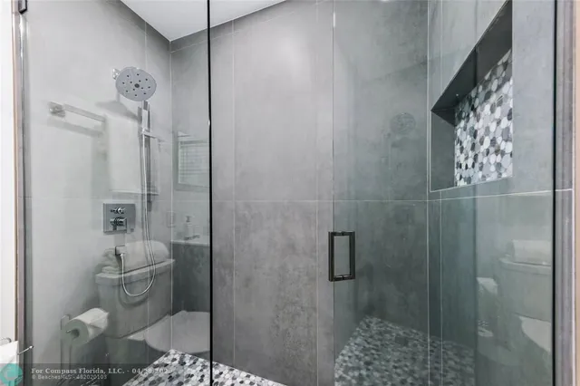 a bathroom with a shower toilet and sink