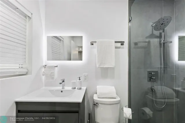 a bathroom with a sink toilet and shower