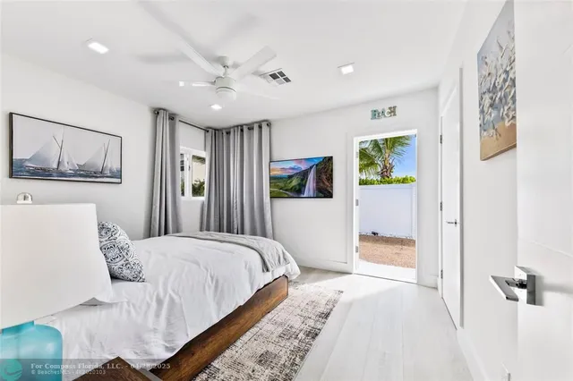 a bedroom with a large bed and a painting on the wall