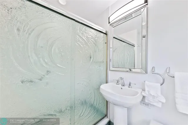 a bathroom with a sink and mirror