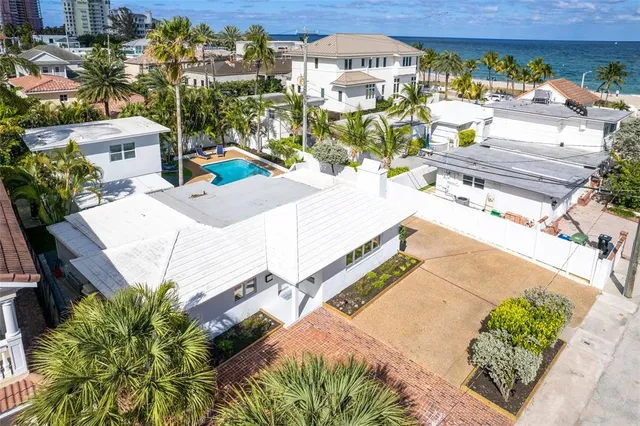 an aerial view of a house with a swimming pool