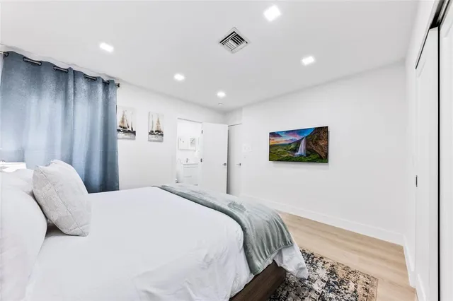 a bedroom with bed and a night stand