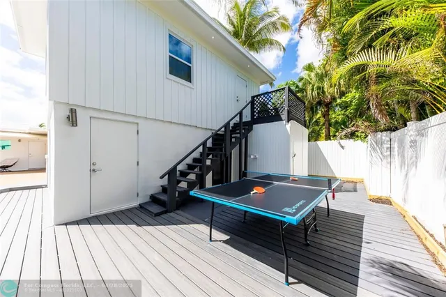 a view of balcony with wooden floor and seating space