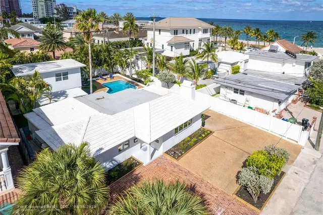 an aerial view of a house with a swimming pool
