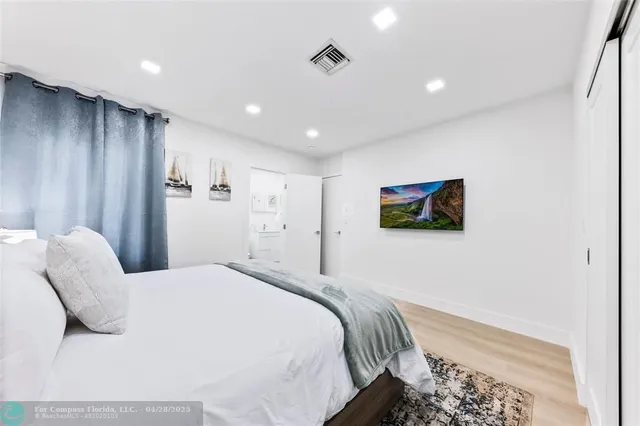 a bedroom with bed and a night stand