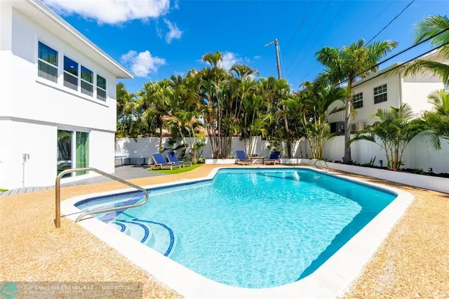 a view of a swimming pool with a lounge chairs
