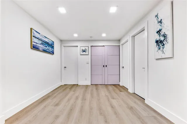 a view of hallway with wooden floor