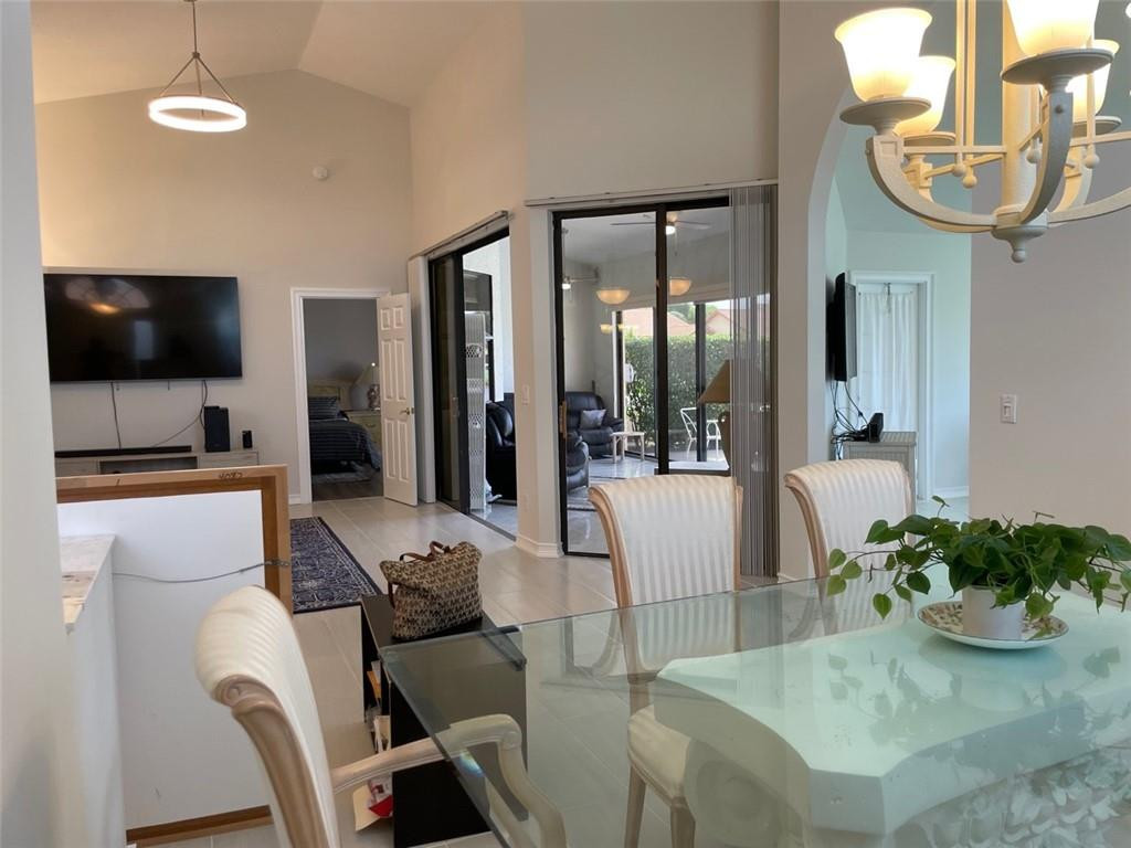 Undisclosed Address Boynton Beach, FL 33472 - Photo 12 of 41 a living room with furniture a flat screen tv and kitchen view