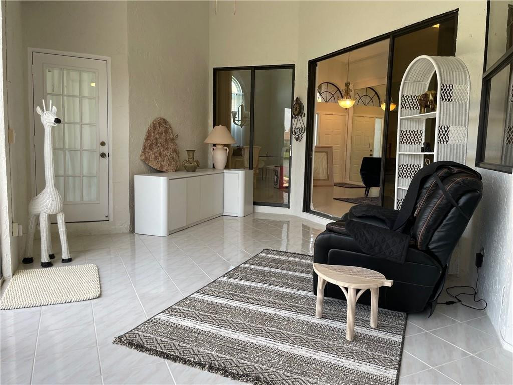 Undisclosed Address Boynton Beach, FL 33472 - Photo 14 of 41 a living room with furniture a lamp and a rug