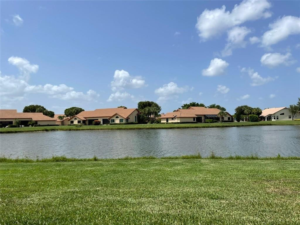 Undisclosed Address Boynton Beach, FL 33472 - Photo 16 of 41 a view of house with yard and outdoor seating