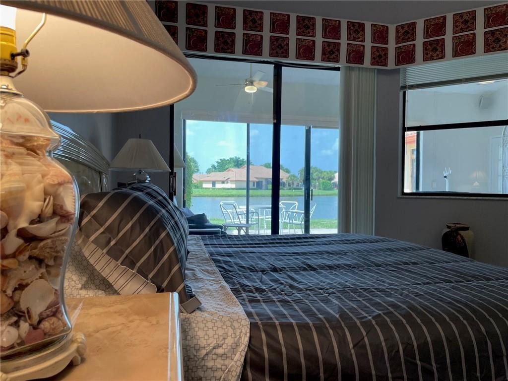 Undisclosed Address Boynton Beach, FL 33472 - Photo 22 of 41 a bed sitting in a bedroom next to a window