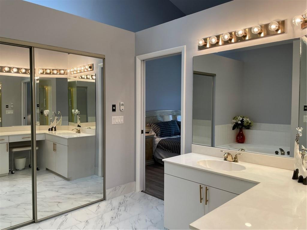 Undisclosed Address Boynton Beach, FL 33472 - Photo 28 of 41 a bathroom with a tub a sink and mirror