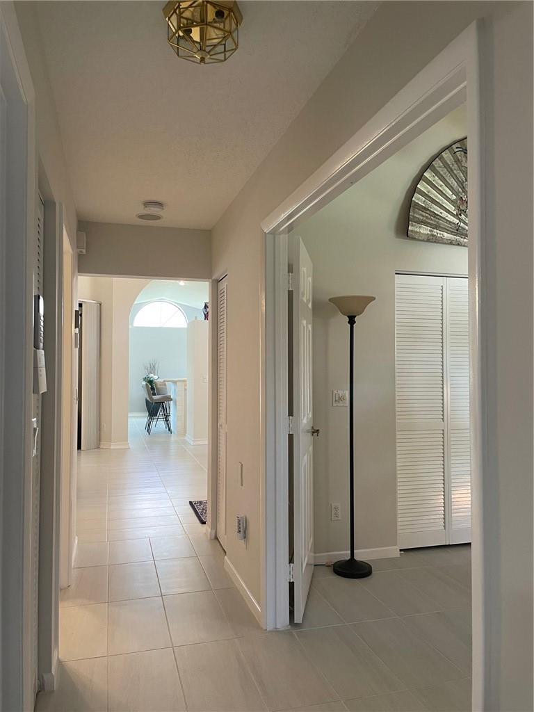 Undisclosed Address Boynton Beach, FL 33472 - Photo 29 of 41 a view of a hallway to a livingroom and a livingroom with furniture