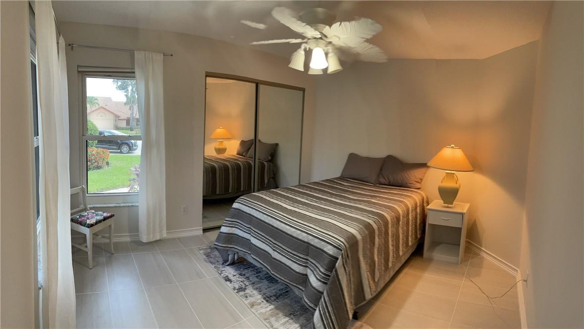 Undisclosed Address Boynton Beach, FL 33472 - Photo 34 of 41 a bedroom with a bed and a chandelier