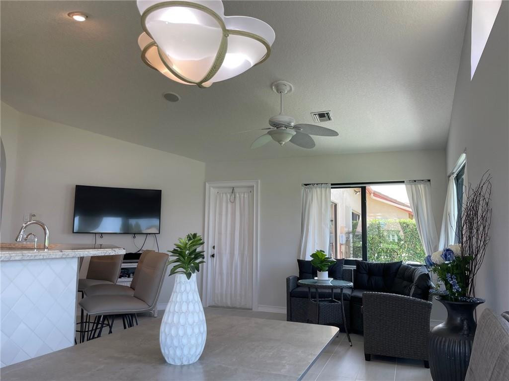 Undisclosed Address Boynton Beach, FL 33472 - Photo 7 of 41 a living room with furniture potted plant and a large window