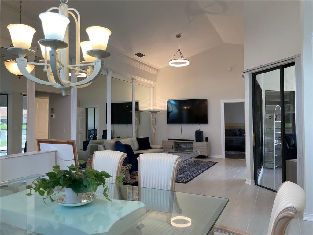 Undisclosed Address Boynton Beach, FL 33472 - Photo 9 of 41 a living room with furniture a flat screen tv and kitchen view