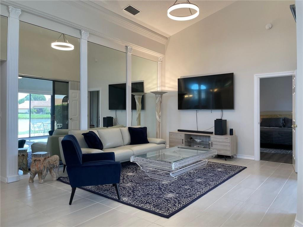 Undisclosed Address Boynton Beach, FL 33472 - Photo 10 of 41 a living room with furniture and a flat screen tv