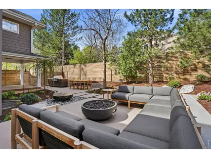 a view of a patio with couches table and chairs and potted plants