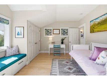 a living room with a bed and a window