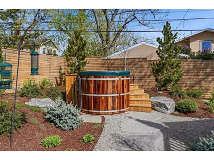 a view of a house with a yard and potted plants