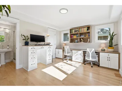 a living room with furniture a flat screen tv and gym equipment