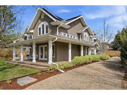 a front view of a house with a yard and potted plants