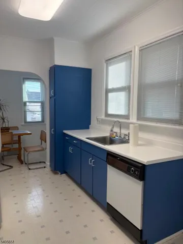 a spacious bathroom with a granite countertop sink and a mirror
