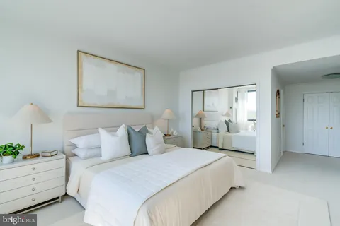 a bedroom with bed and white walls