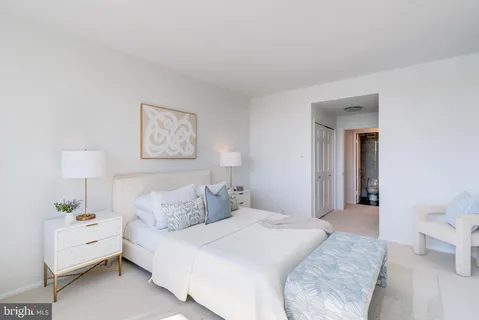 a bedroom with a bed and a lamp