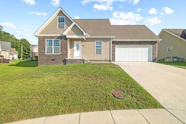 a front view of a house with a yard and garage
