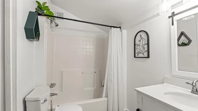 a bathroom with a shower curtain and a sink